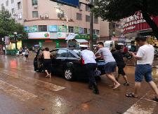 暴雨过后，他们打着赤脚、挥舞双臂指挥交通